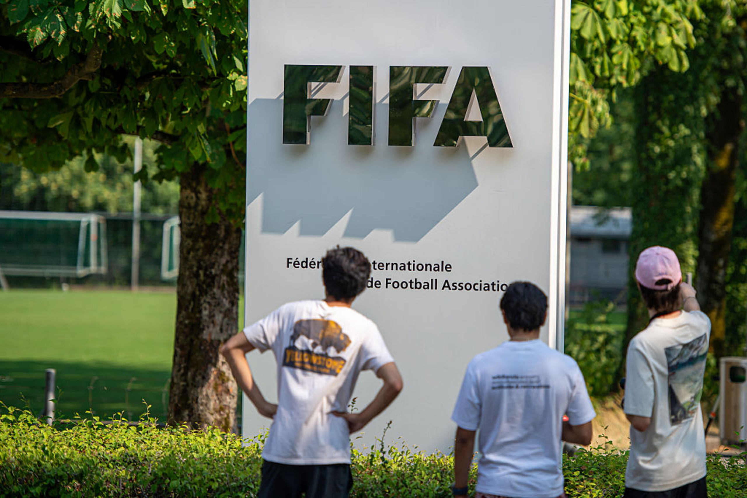 Tabla z napisom FIFA, ki si jo ogledujejo ljudje.